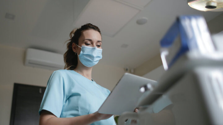 image shows nurse checking health app