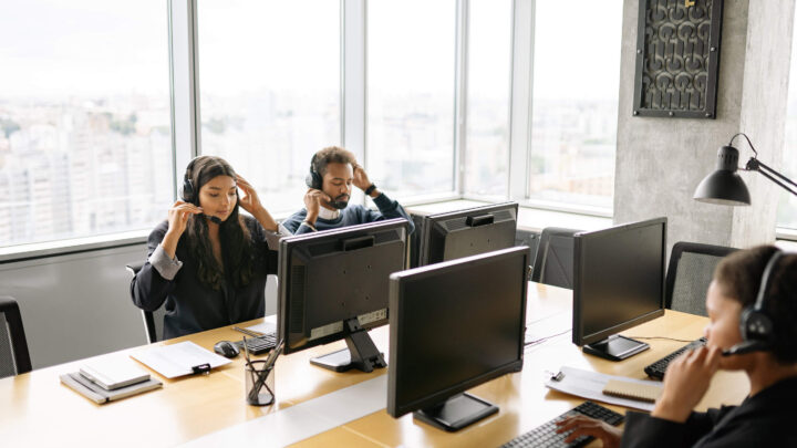 image shows people using headsets in an office